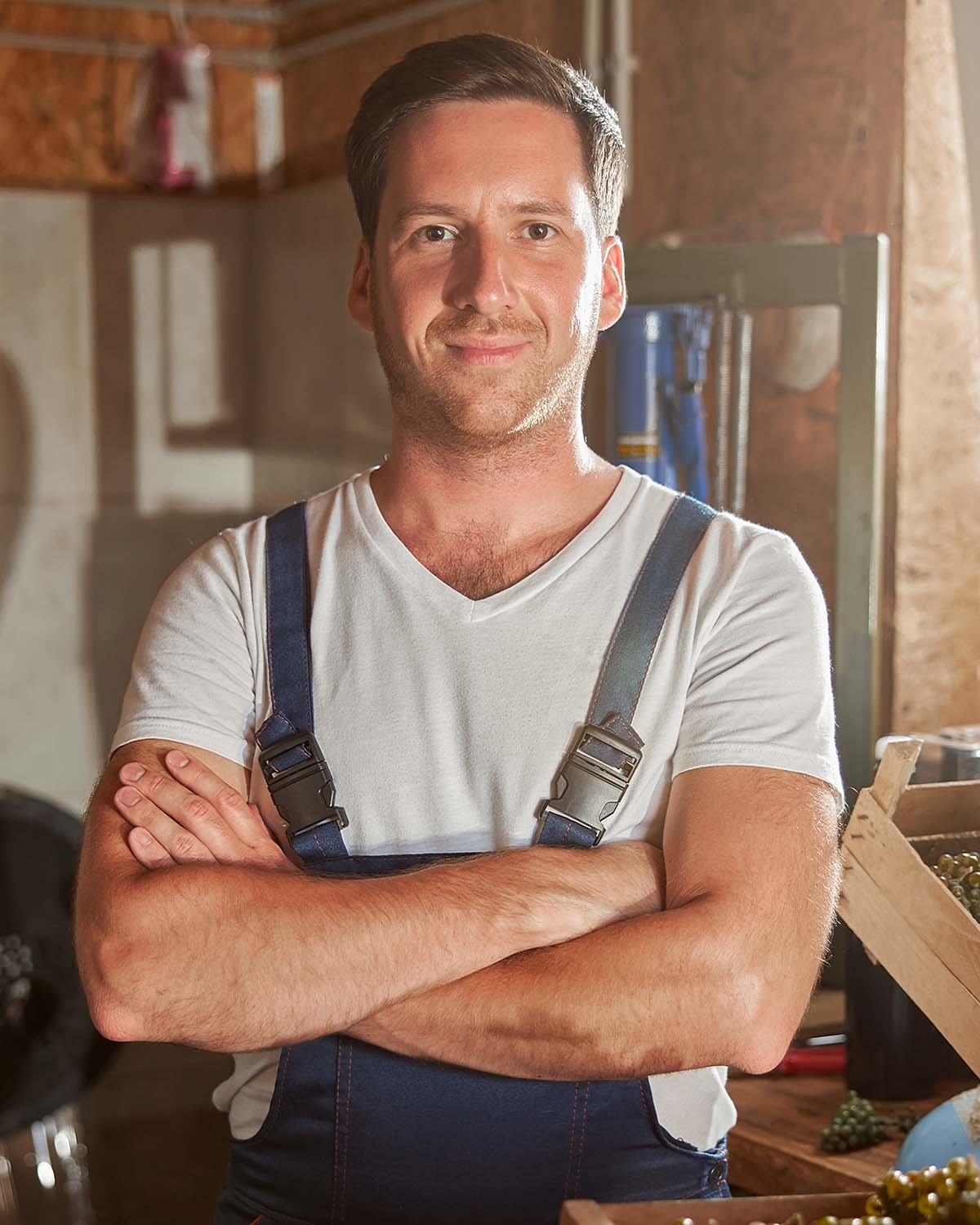 handsome-male-winemaker-posing-at-the-winery-NP6YNDZ.jpg